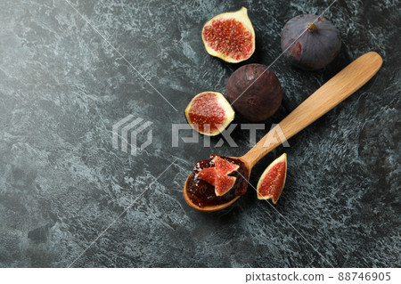 Spoon with fig jam and ingredients on black smokey background 88746905