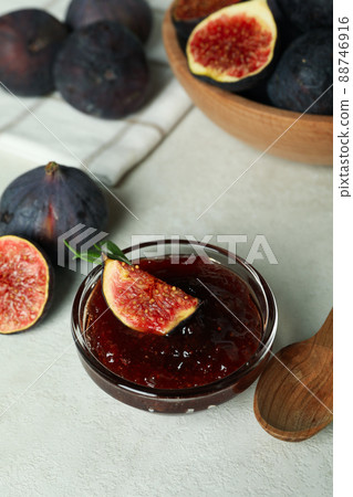 Concept of tasty food with fig jam on white textured background 88746916