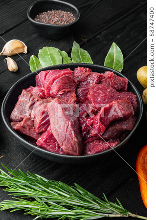 Fresh raw chopped beef, on black wooden background 88747400