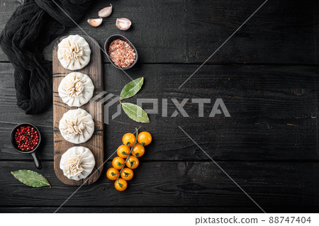 Homemade, traditional chinese pan fried dumplings, on black wooden table background, top view flat lay, with copy space for text Homemade, traditional chinese pan fried dumplings, on black wooden table background, top view flat lay, with copy space for text 88747404