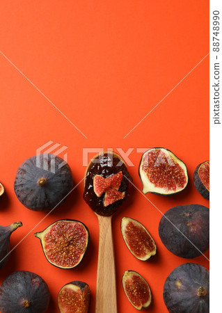 Spoon with fig jam and ingredients on orange background Spoon with fig jam and ingredients on orange background 88748990
