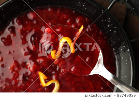 Dish and spoon with cranberry sauce, close up Dish and spoon with cranberry sauce, close up 88749059