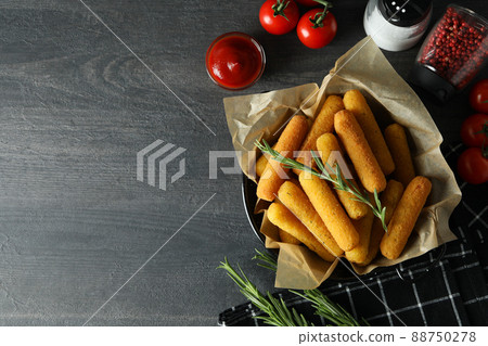 Concept of tasty food with cheese sticks on dark wooden table 88750278