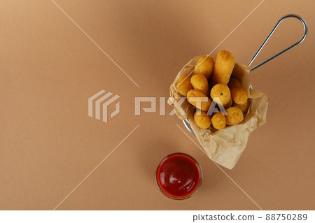 Cheese sticks and ketchup on brown background 88750289