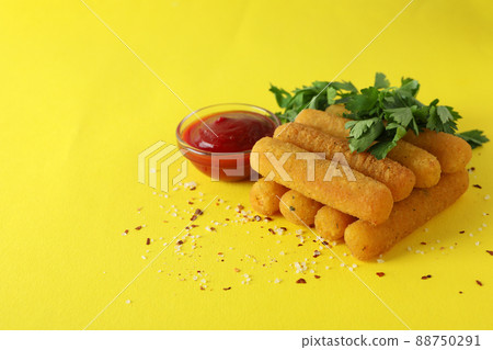 Cheese sticks, spices, ketchup and parsley on yellow background 88750291