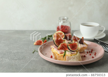 Concept of tasty food with bruschetta with fig on gray textured table Concept of tasty food with bruschetta with fig on gray textured table 88750313