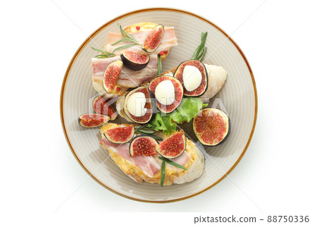 Plate with bruschetta with fig isolated on white background Plate with bruschetta with fig isolated on white background 88750336