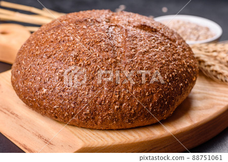 Fresh baked brown bread with ears and grains of wheat 88751061