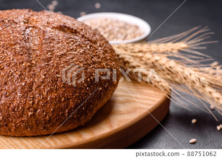Fresh baked brown bread with ears and grains of wheat 88751062