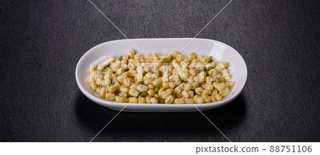 Organics fresh Baby Green Bean Sprouts in white ceramic bowl on a dark concrete background 88751106