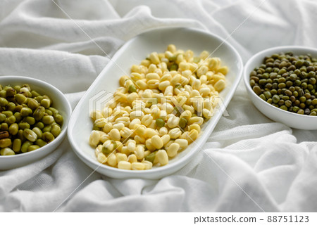 Organics fresh Baby Green Bean Sprouts in white ceramic bowl on a dark concrete background 88751123