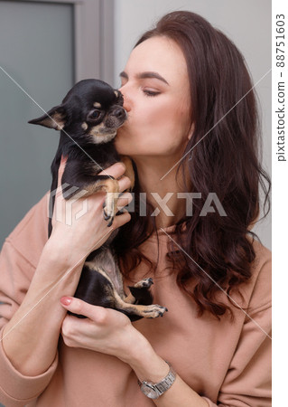 Girl kissing hugging dog pet cute adorable red dog friendly closeup closing eyes funny animals Girl kissing hugging dog pet cute adorable red dog friendly closeup closing eyes funny animals 88751603