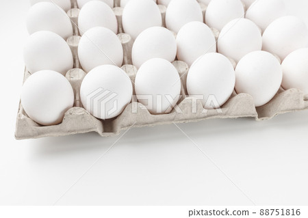 Fresh raw 30 pack of large eggs white eggs in cardboard. Consumerism, egg production concept Fresh raw 30 pack of large eggs white eggs in cardboard. Consumerism, egg production concept 88751816