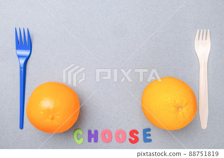 Plastic fork, plastic toy orange, wooden fork and natural orange. Flat lay. Plastic fork, plastic toy orange, wooden fork and natural orange. Flat lay. 88751819
