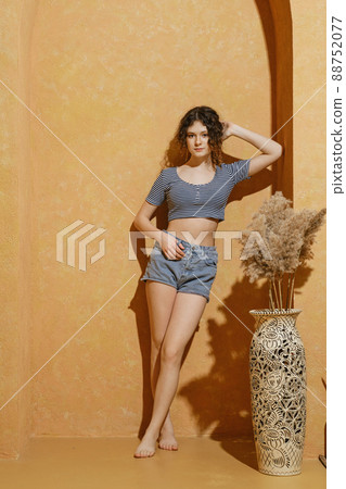 Teenager girl leaning against the arch in sunny day Teenager girl leaning against the arch in sunny day 88752077