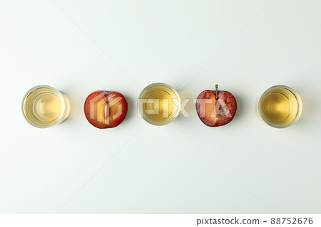 Plum vodka shots and ingredients on white background Plum vodka shots and ingredients on white background 88752676