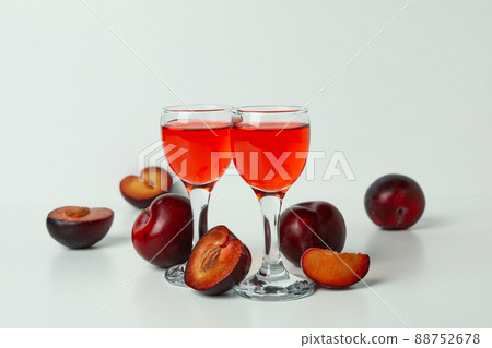 Plum brandy shots and ingredients on white background Plum brandy shots and ingredients on white background 88752678
