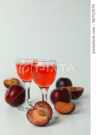 Plum brandy shots and ingredients on white background 88752679