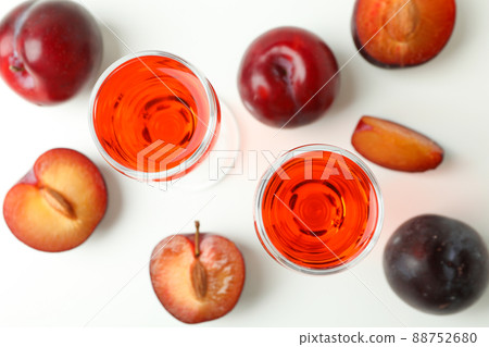 Plum brandy shots and ingredients on white background Plum brandy shots and ingredients on white background 88752680