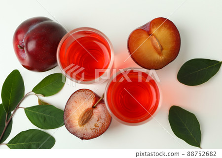 Plum brandy shots and ingredients on white background 88752682