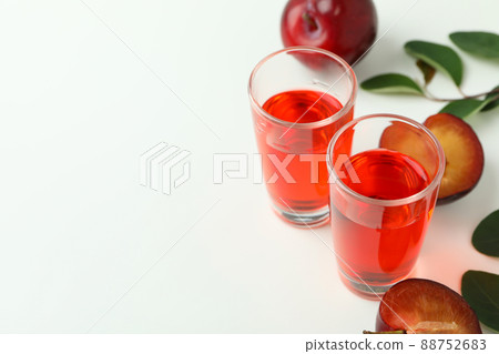 Plum brandy shots and ingredients on white background 88752683