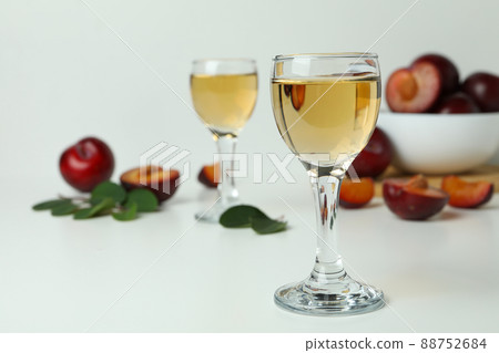 Plum vodka shots and ingredients on white background Plum vodka shots and ingredients on white background 88752684