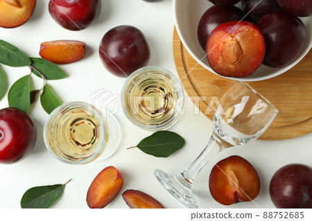 Plum vodka shots and ingredients on white background Plum vodka shots and ingredients on white background 88752685