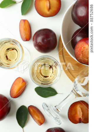 Plum vodka shots and ingredients on white background Plum vodka shots and ingredients on white background 88752686