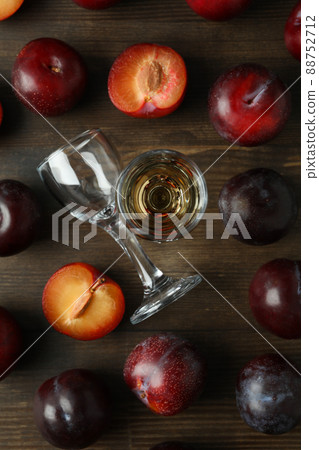 Plum vodka shot and ingredients on wooden table Plum vodka shot and ingredients on wooden table 88752712