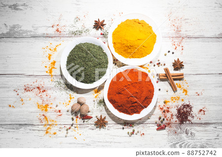 Various spices in a bowls on white wooden background. Top view with copy space. Cooking ingredients and condiments concept. 88752742