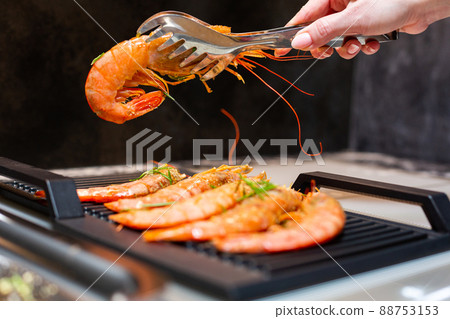 Close-up. Tiger prawns are fried on an electric grill in the kitchen. 88753153
