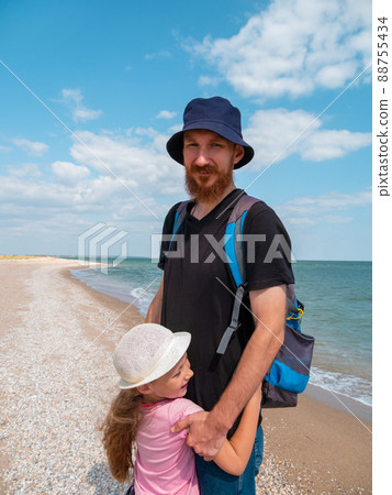 Happy family father daughter hugging on marine landscape. Bearded dad with child in hands having fun together 88755434