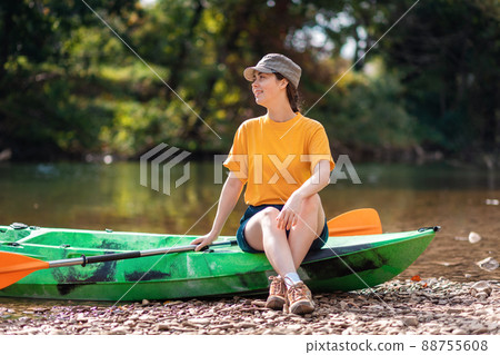 Summer kayaking. A beautiful smiling woman sitting on a kayak. Recretion at the national park 88755608