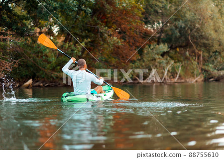 Kayaking on the river. Adult man floating at the kayak. Back view. Copy space. The concept of the World Tourism Day 88755610