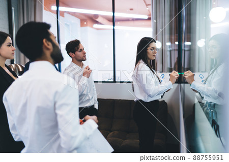 Concentrated diverse coworkers brainstorming in office Concentrated diverse coworkers brainstorming in office 88755951