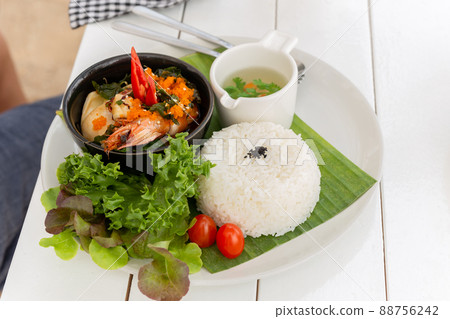 Thai famous dish pad kra pao stream rice with king prawn and vegetable soup. Thai famous dish pad kra pao stream rice with king prawn and vegetable soup. 88756242