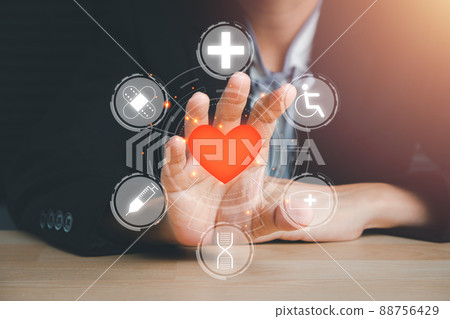 Person hand holding red heart icon on virtual screen, heart health insurance, charity volunteer donation, CSR responsibility, world heart day, world health day, family day, saving lives.... 88756429