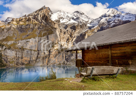 Oeschinnensee, wooden chalet and Swiss Alps, Switzerland. 88757204