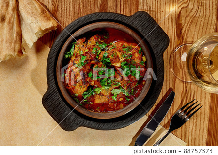 Traditional Georgian Chashushuli of stewed veal with onion, herbs and tomato gravy 88757373