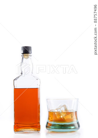 Bottle of whisky and glass of whisky with ice isolated on white background with copy space. Bottle of whisky and glass of whisky with ice isolated on white background with copy space. 88757496