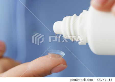 Drop of medical solution on soft contact lens closeup Drop of medical solution on soft contact lens closeup 88757913