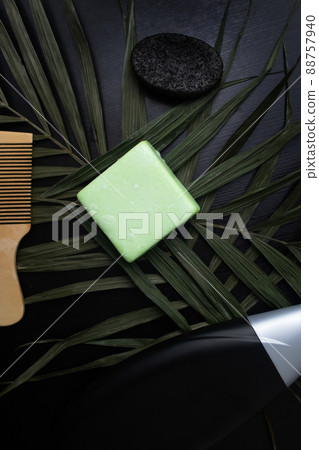 Solid hair shampoo. Composition of golden curls, soap suds, solid shampoo and comb. The concept of female care for long hair. Solid hair shampoo. Composition of golden curls, soap suds, solid shampoo and comb. The concept of female care for long hair. 88757940