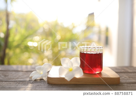 Red grape juice and flower on wooden table Red grape juice and flower on wooden table 88758871