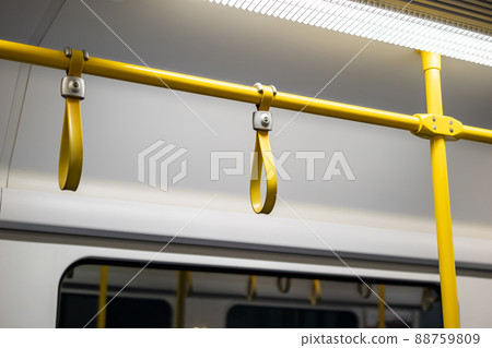 Close up the rubber - plastic cable hand holding in ariport rail link train. Close up the rubber - plastic cable hand holding in ariport rail link train. 88759809