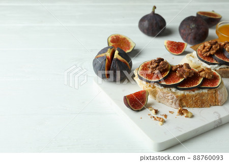 Concept of tasty food with bruschetta with fig on white wooden table Concept of tasty food with bruschetta with fig on white wooden table 88760093