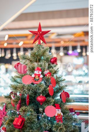 The big red star decoration topped of the Christmas's tree. 88761072