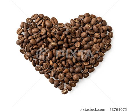 Organic coffee beans in a heart shape isolated on white background. Organic coffee beans in a heart shape isolated on white background. 88761073