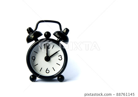 Black alarm clock isolated on white background. The clock set at 10 o'clock. Black alarm clock isolated on white background. The clock set at 10 o'clock. 88761145