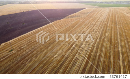 Aerial drone view flight over different agricultural fields field after harvest Aerial drone view flight over different agricultural fields field after harvest 88761417