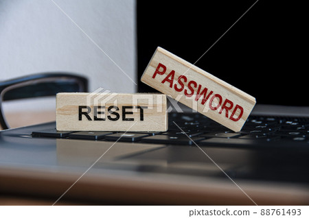 Rest password text on wooden blocks on top of a laptop. Online security and password concept Rest password text on wooden blocks on top of a laptop. Online security and password concept 88761493